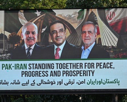 An electronic board shows the three leaders pictured above the words: Pak-Iran standing together for peace, progress and prosperity.