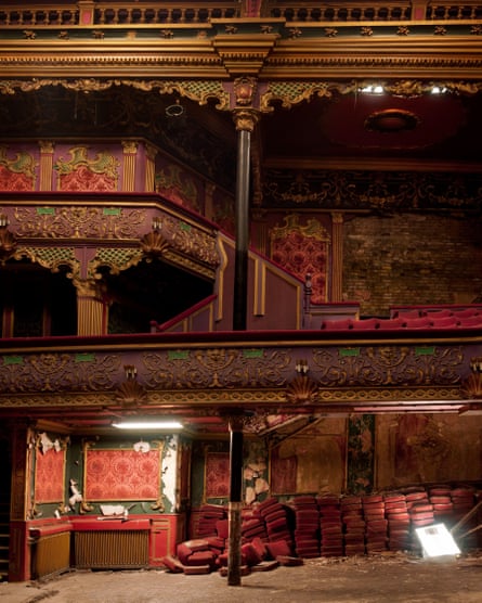 Inside the dilapidated building ,showing the rococo plasterwork and the bare floor and red velvet seat pads on the floor