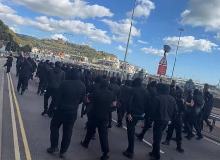 Masked people on the road in Dover.