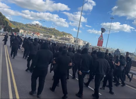 Masked people on the road in Dover.