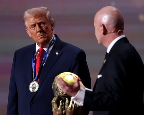 Trump listens as Infantino tells him how great he is.