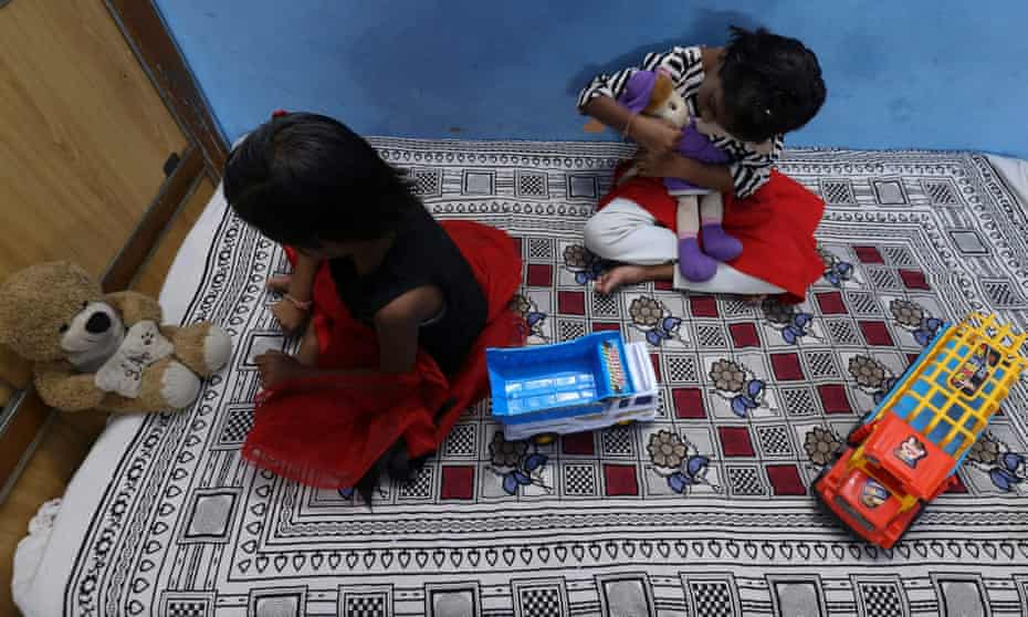 Twin sisters Tripti and Pari, who lost both their parents due to the Covid-19 coronavirus, play with their toys at a relative’s home in Bhopal.