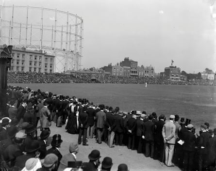 Spectators standing to watch the play at the Oval cricket ground.