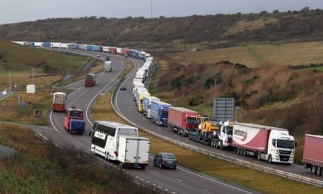 Lorries queue on the A20 to enter the port of Dover in Kent. A ban on travel to France has added another layer of complexity to Christmas stockpiling and Brexit uncertainty.