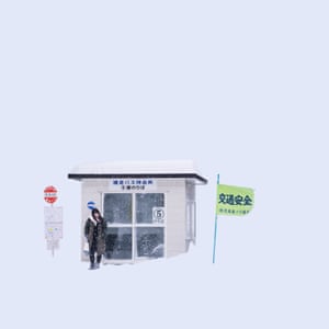 An image of woman waiting at a bus stop in the snow from Chinese photographer Ying Yin’s series Wind of Okhotsk