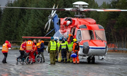 Passengers are helped out of a rescue helicopter after being rescued from cruise ship Viking Sky in Hustadvika.