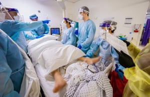 Theo Reback helps with proning a Covid-19 patient.