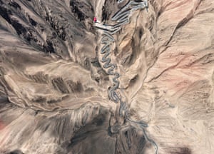 Overhead view of a twisty road in largely barren mountainous terrain