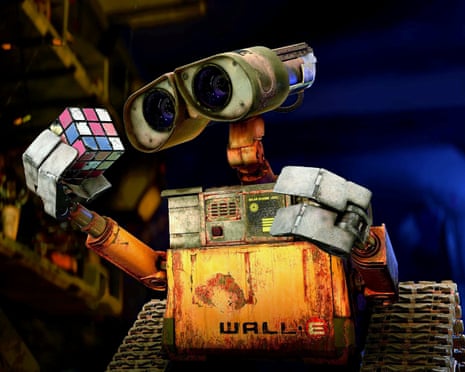 Wall-E, the rusty robot, holds up a colorful Rubik's cube with its claw