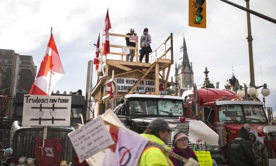 Demonstrators gather along Wellington Street as a protest against Covid-19 restrictions