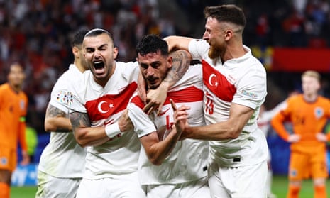 Samet Akaydin (centre) celebrates with his teammates after opening the scoring against Netherlands.