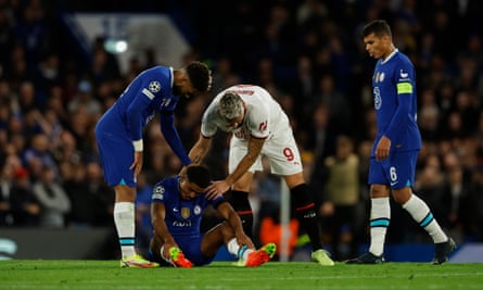 Chelsea’s Wesley Fofana sits on the pitch after picking up an injury against Milan