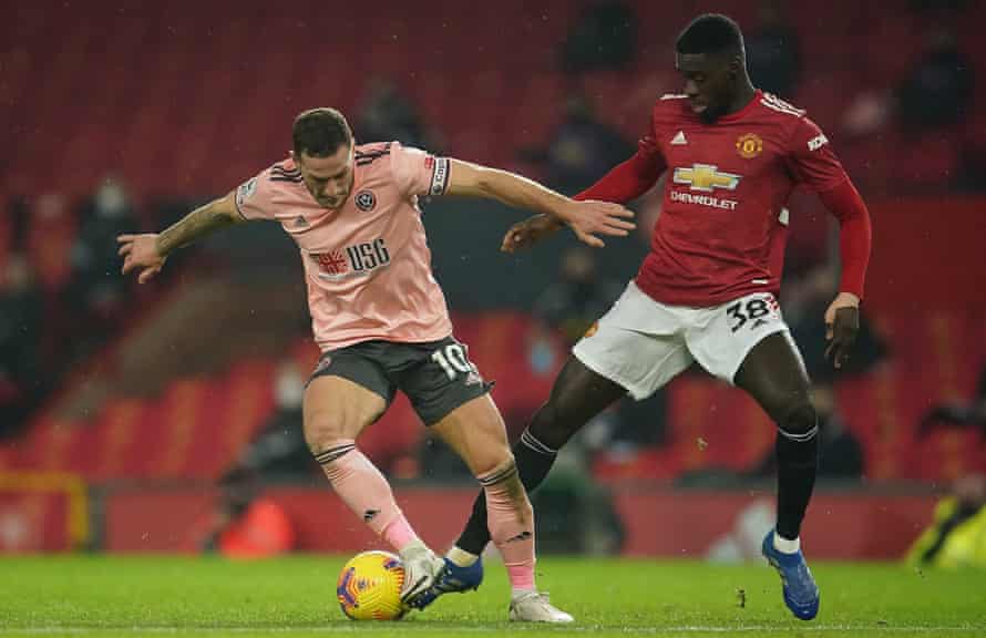 Axel Tuanzebe battles with Sheffield United’s Billy Sharp.