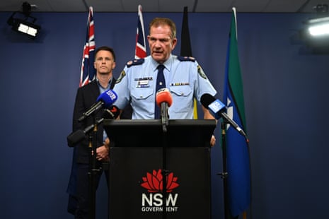 Deputy police commissioner David Hudson speaks to media as Premier Chris Minns looks on