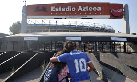 Two fans outside the Estadio Azteca, scene of Maradona’s greatest triumph.