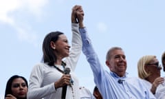 Maria Corina Machado and Edmundo Gonzalez raise their hands together in a victorious gesture as they address supporters, 30 July 2024