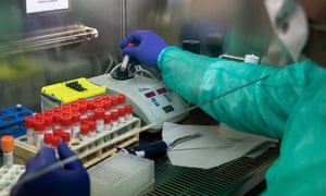 A lab worker conducting a coronavirus swab test process.