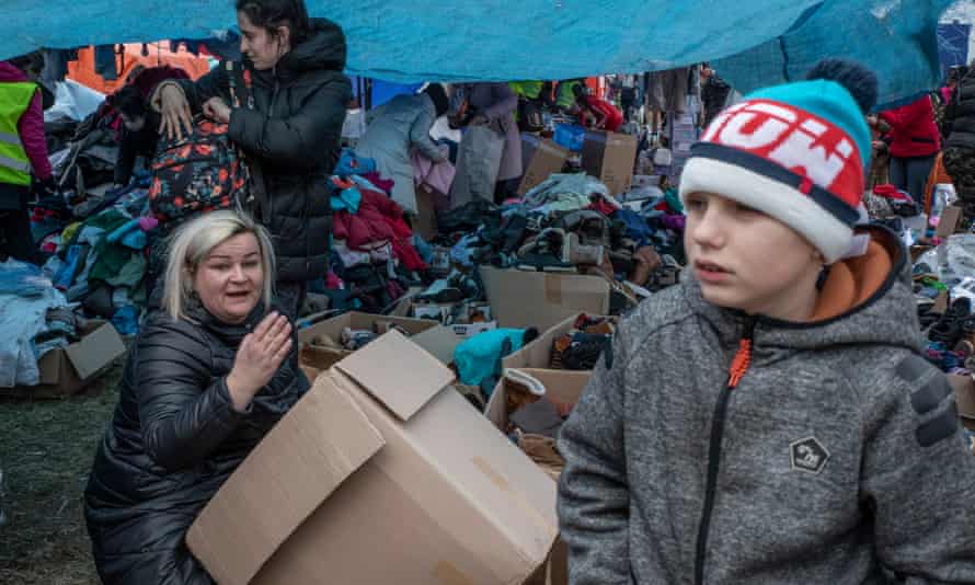 A woman and boy being given clothes.