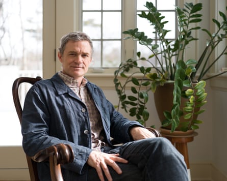 Patrick Radden Keefe indoors, in a wooden chair