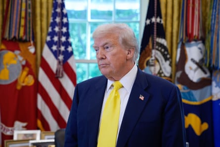 Donald Trump in the Oval Office wearing a yellow tie looking unhappy