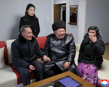Kim Jong-un and his daughter Kim Ju-ae (back L) visiting the families of fallen soldiers moving into their homes on the new Saeppyol Street in Pyongyang