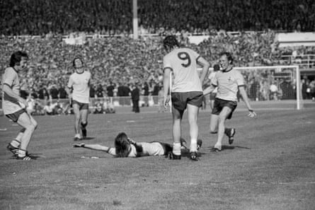 Arsenal player Charlie George lies on the ground and throws his arms in the air after scoring the winning goal during extra time for Arsenal in the 1971 FA Cup final against Liverpool at Wembley. This win gave them the League-FA Cup double.