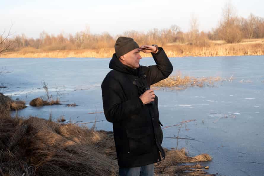 Alexander Vintchevski, founder of Birdlife Belarus, scans the swamps for birds in Pripyat National Park in the Gomel region.
