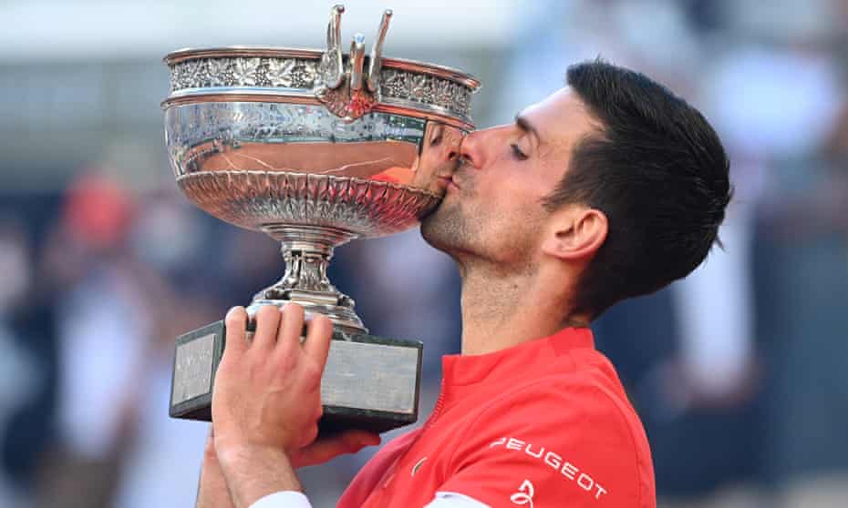 Novak Djokovic kisses the trophy after winning the French Open men's singles final against Stefanos Tsitsipas of Greece