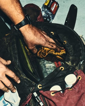A man packs his equipment before going into the field