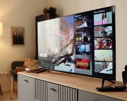 Flat-screen TV displaying various multimedia options in a cosy, well-lit room with warm lighting and comfortable furnishings creating a relaxing atmosphere suitable for unwinding