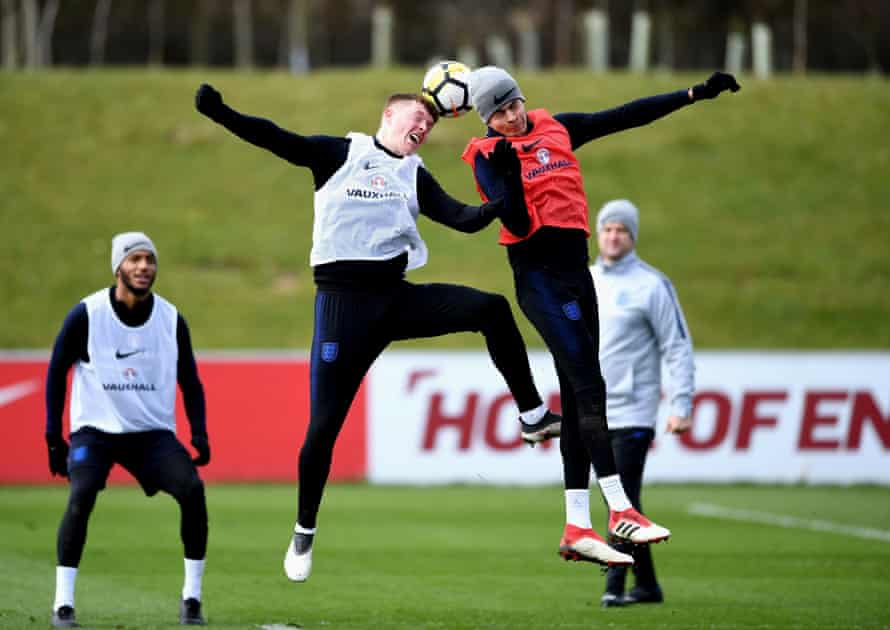 Alfie Mawson, left, and Dele Ali go up for a header during an England training session at St Georges Park.