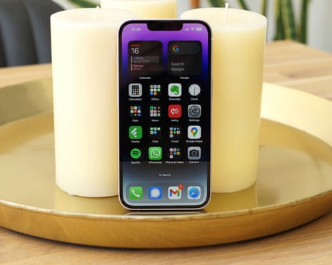 Apple iPhone 14 review showing phone resting on candles.