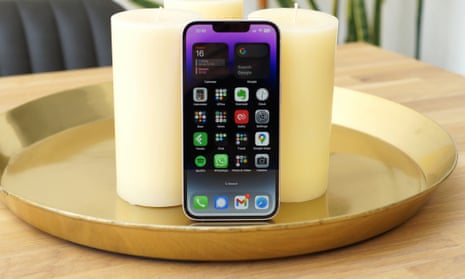 Apple iPhone 14 review showing phone resting on candles.