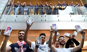 First customers display their iPhone X sets at an Apple showroom in Sydney on Friday, 3 November.