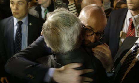 Belgian prime minister Charles Michel embraces European commission president Jean-Claude Juncker at a makeshift memorial in front of the stock exchange at the Place de la Bourse (Beursplein) in Brussels.