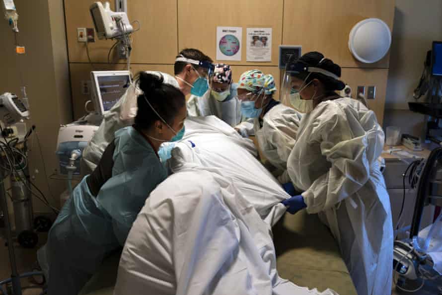 Medical personnel treat a coronavirus patient at Providence Holy Cross medical center in the Mission Hills section of Los Angeles last month.