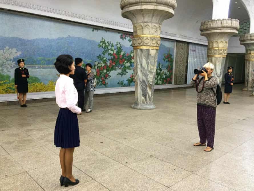 Noroc taking a portrait in a Pyongyang subway station.