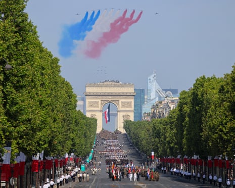France’s Air Force Elite aerobatic flying team “Patrouille de France” (PAF) releases trails of France’s national colours as they perform a flyover during the annual Bastille Day military parade.