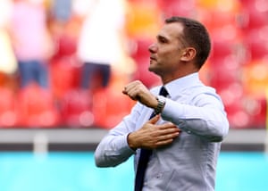 Ukraine coach Andriy Shevchenko celebrates with the fans after the match.