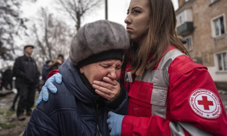 A woman cries in front of the building which was destroyed by a Russian attack in Kryvyi Rih.