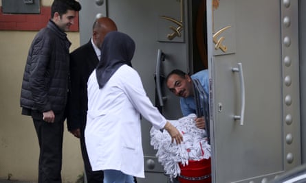 Saudi officials and cleaning workers enter the Saudi consulate in Istanbul, Turkey.