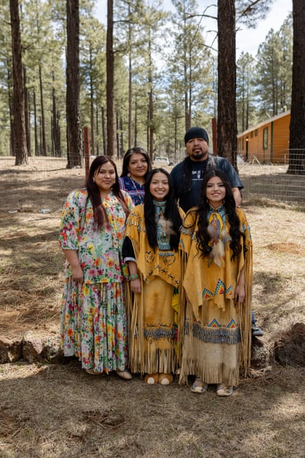 five people stand together for a group picture