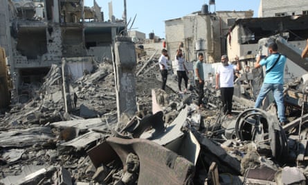 Palestinians inspect the destruction following Israeli airstrikes in Rafah in the southern Gaza Strip
