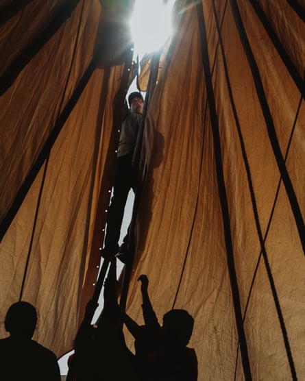 People raising a tarp.