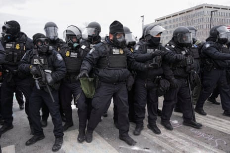 U.S. Customs and Border Protection (CBP) agents stand in formation as they face protesters during a demonstration outside the Whipple Federal Building, more than a week after a U.S. Immigration and Customs Enforcement (ICE) agent fatally shot Renee Nicole Good on January 7, in Minneapolis, Minnesota, U.S.