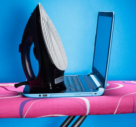 Iron and laptop on ironing board, against blue and pink background