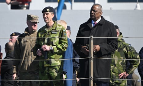 The supreme commander of the Swedish armed forces, Gen Micael Byden, centre, and the US secretary of defence, Lloyd Austin, right, on board HMS Härnösand at the Muskö naval base, south of Stockholm.