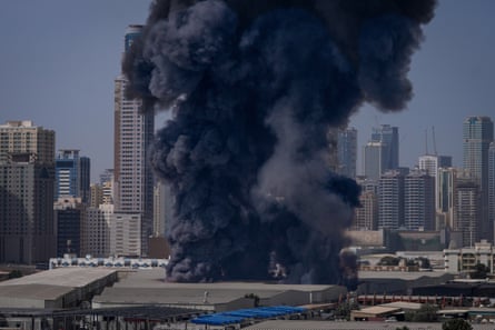 Smoke rises from a warehouse in the industrial area of Sharjah City near Dubai.