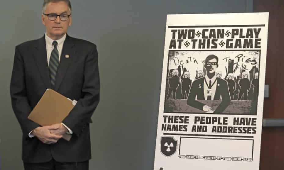 US attorney Brian Moran stands next to a poster that was mailed earlier in the year to the home of Chris Ingalls, an investigative reporter with KING-TV in Seattle, during a news conference on 26 February.