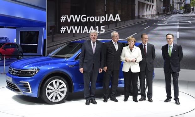 Volkswagen CEO Martin Winterkorn, second from left, stands next to Angela Merkel